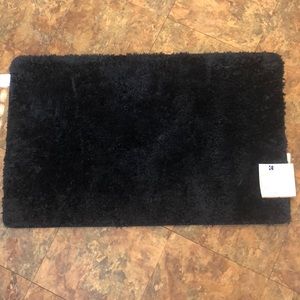 Black, fuzzy bath rug